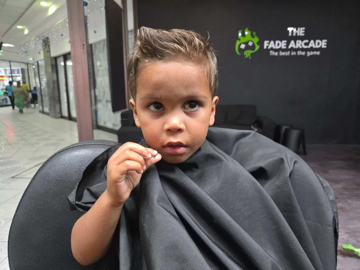 Young client smiling in the barber chair